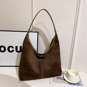 Minimalist brown suede hobo shoulder bag with contrast stitching and retro bucket design