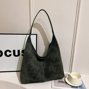 Retro dark green matte suede hobo bag with vertical stitching on white minimalist backdrop