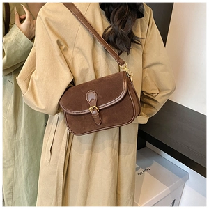 Detail view of brown matte suede shoulder bag featuring retro metal buckle closure
