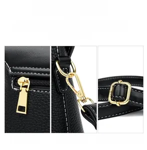 Detailed close-up of premium golden metal hardware and black lychee texture leather finish