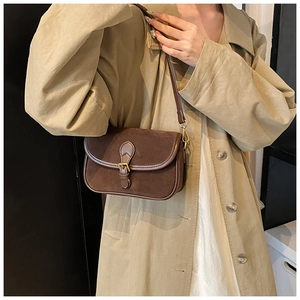 Retro matte suede shoulder bag with leather trim and buckle detail shown on a model