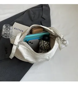 Internal view of large white crescent tote bag showing spacious capacity for daily essentials