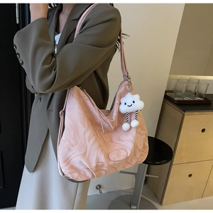 Detail of light pink marble pattern hobo bag with cute white cloud plush pendant charm
