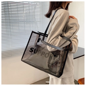 Detail view of transparent black PVC tote bag featuring Support logo with leather strap