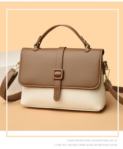 Detailed close-up of retro brown two-tone messenger bag with textured lychee grain leather
