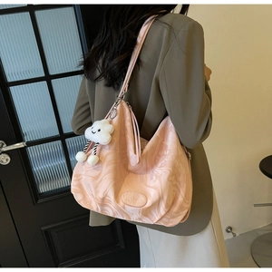 Pink marble pattern tote bag shown over the shoulder with a soft cloud charm detail