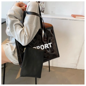Detail of transparent black PVC tote bag with inner pouch and white PORT lettering