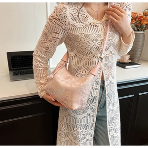 Pink jacquard crescent bag with Chinese landscape pattern shown on a model's shoulder