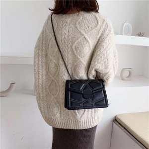 Minimalist black chain shoulder bag with geometric quilting and metallic rivet details