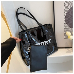 Detail of transparent black tote bag with white SPORT text and matching pouch