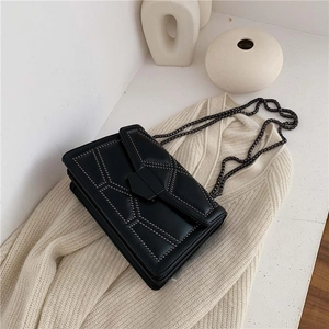 Chic black leather crossbody bag with geometric rivet patterns and dark grey metal chain strap