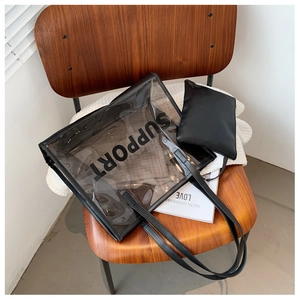 Close-up of transparent PVC tote with SUPPORT text and internal black leather pouch
