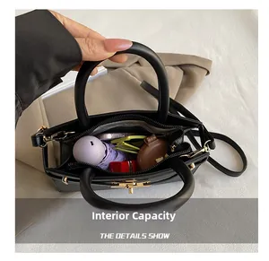 Top view of spacious interior holding umbrella, sunglasses and lipstick in black bag