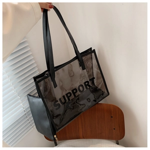 Detail of transparent PVC tote bag with Support text and black faux leather inner pouch