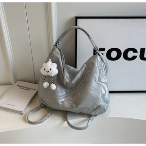 Detail of grey marble tote bag with MUON SHARP logo and white cloud plush charm