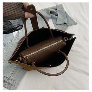 Detailed interior view of a dark brown tote bag with its removable zippered inner pouch