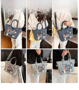 Detail of cartoon print denim tote bag showing multi-way straps and spacious design