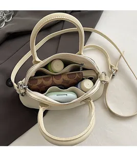 Interior view of small crossbody bag showing spacious capacity for phone and cosmetics