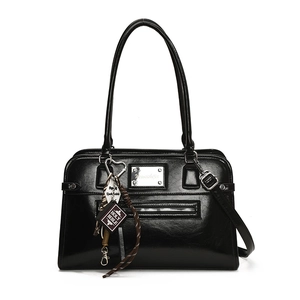 Glossy black leather handbag with silver logo plate and unique Holy Bible charm