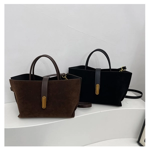 Dual minimalist suede tote bags in brown and black with gold oval metal buckle accents