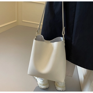 Detailed close-up of white lychee pattern leather tote bag with elegant shoulder strap