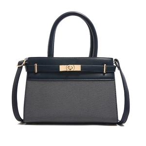 Elegant navy blue patchwork tote bag with gold metal twist lock and shoulder strap