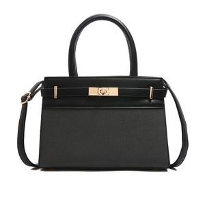 Elegant black leather and fabric trapezoid handbag with gold hardware for women