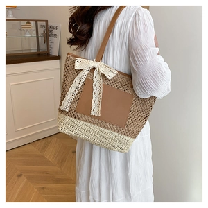 Detail of handwoven tote bag with dark brown mesh, creamy white base and lace bow accent