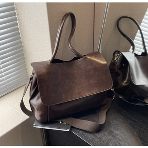 Detail der braunen Vintage-Einkaufstasche mit breitem Gurt und weichem Design
