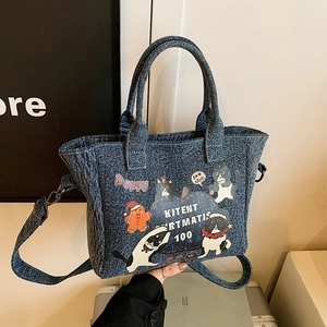 Deep blue denim tote bag with cute cartoon cat prints and adjustable shoulder strap