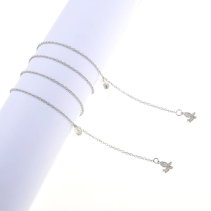 Silver eyewear chain with zircon butterfly pendant on a minimalist white display