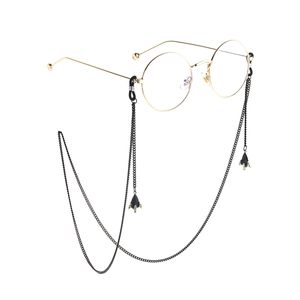 Fashionable round gold metal glasses with sleek black chain and airplane style pendants