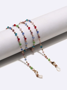 Detail of colorful faceted crystal beads and gold spacers on a non-slip eyewear chain