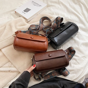 Retro cylinder crossbody bags with vintage patterned wide straps in brown and black