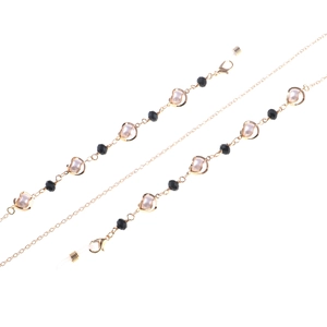 Elegant gold glasses chain with pearl accents and black faceted beads for eyewear