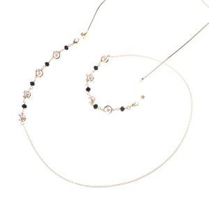 Elegant gold glasses chain with white pearls and black beads for stylish eyewear accessory