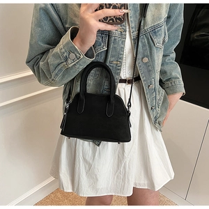 Chic black litchi pattern leather handbag with crossbody strap shown in a mirror selfie view