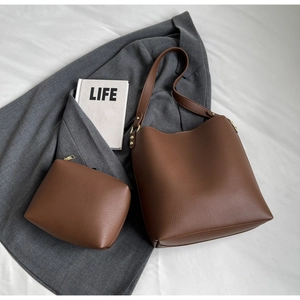 Detailed view of brown lychee grain leather tote bag set with matching zipper pouch
