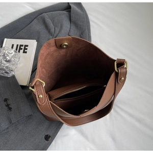 Top view of brown lychee leather tote bag with internal zipper pouch and magnetic clasp