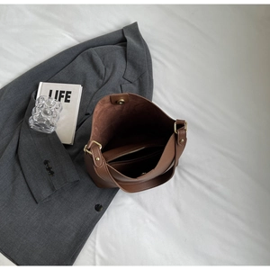 Internal view of brown leather tote bag showing large capacity and magnetic closure