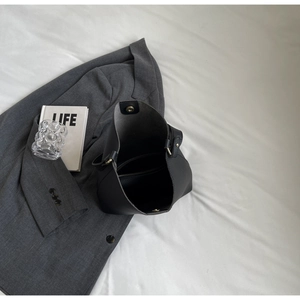 Top-down view of black lychee leather tote bag interior with magnetic closure and zip pocket