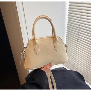 Close-up of cream PU leather handbag showing lychee texture and silver hardware details