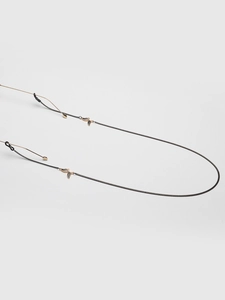 Detail of black metal eyewear chain with golden butterfly pendant and non-slip rubber loops