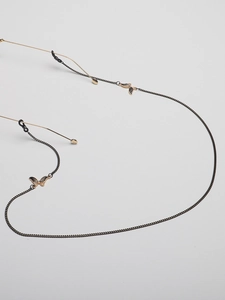 Detail of black metal glasses chain with rhinestone butterfly pendants and rubber loops
