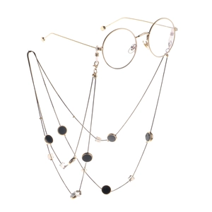 Goldene Brillenkette mit schwarzen Anhängern und klaren Kristallperlen im Duo-Design