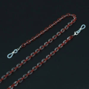 Detail of red and white acrylic eyewear chain with silver hooks on black background