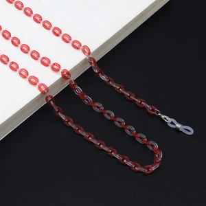 Detail of red and clear acrylic eyeglass chain with metal clasps and silicone loops