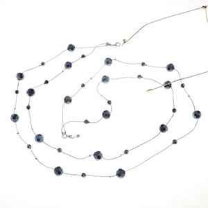 Detail of beaded glasses chain with grey crystals and silicone loops on gold frames