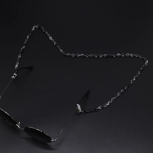 Detail of translucent black tortoise resin glasses chain with adjustable silicone loops