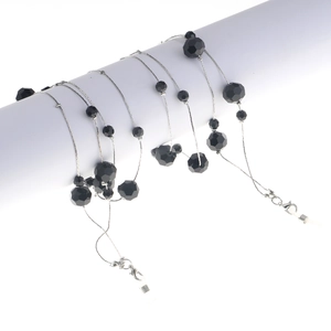 Detailed view of black faceted bead chain with silver metal links and silicone loops